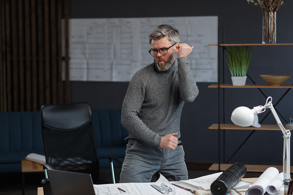 Image of a man dancing in an office.
